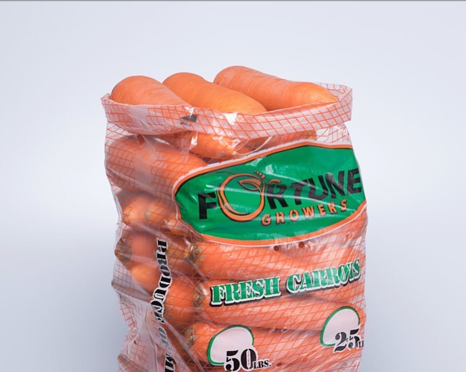 A mesh bag of Fortune Growers fresh carrots.