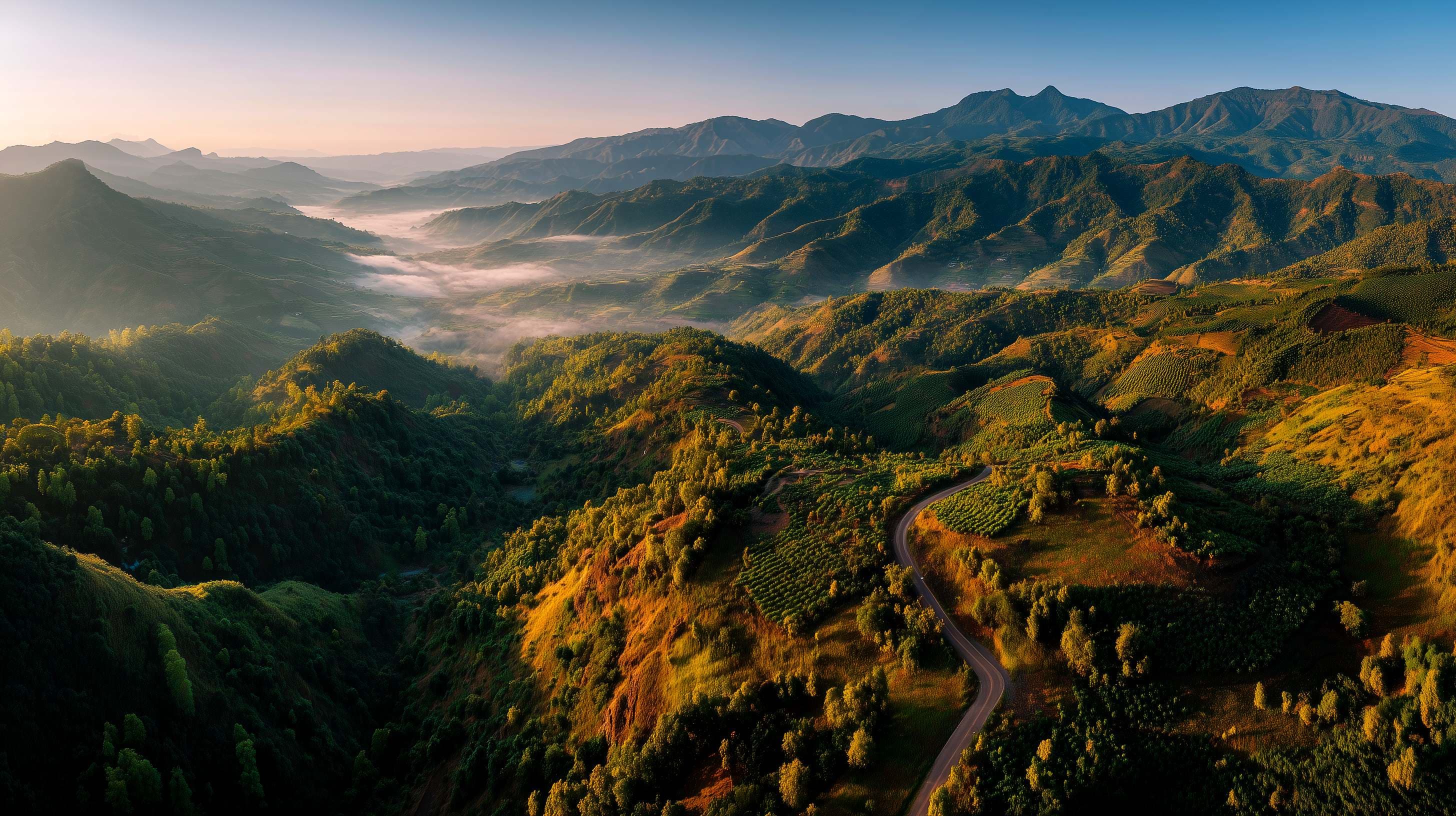 Mountain farmland at sunrise across open agricultural land